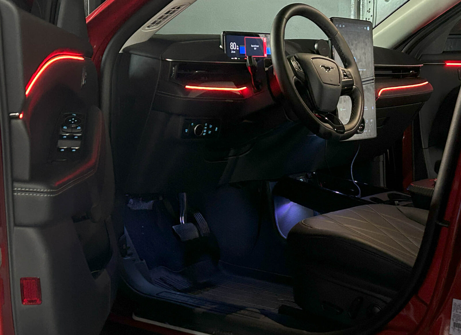 Red ambient lighting across the dash and doors of an SUV